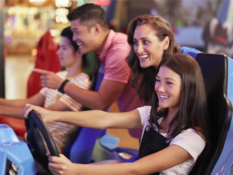 Group playing the latest driving game