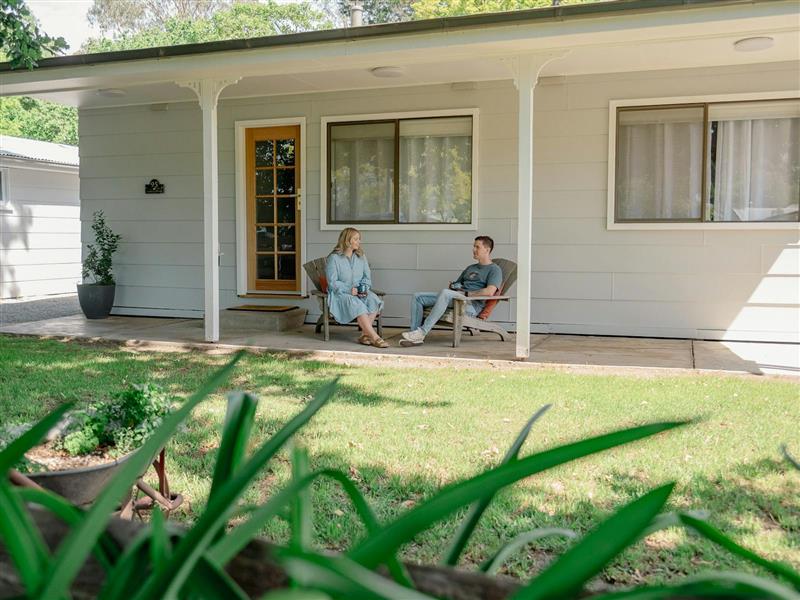 two people sitting at front of cottage