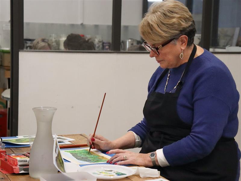 A student painting on paper