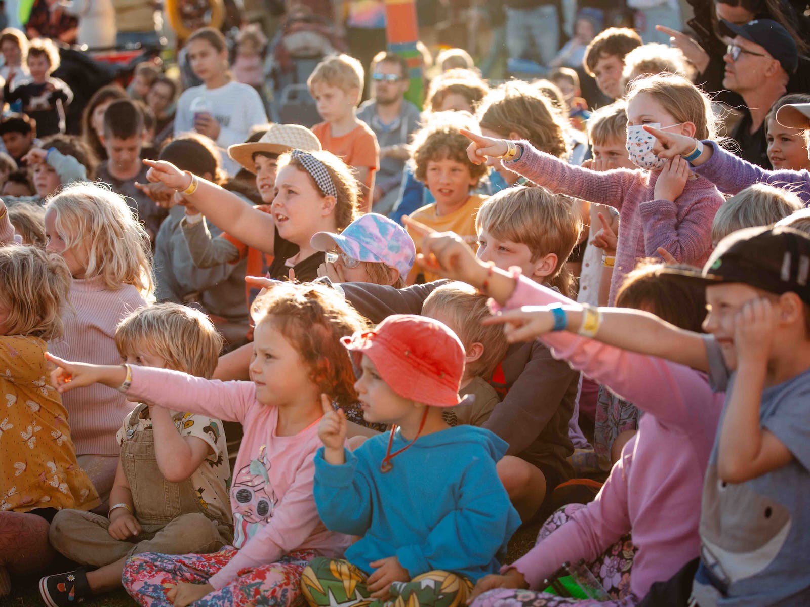 Children pointing and smiling at the Port Fairy Folk Festival.