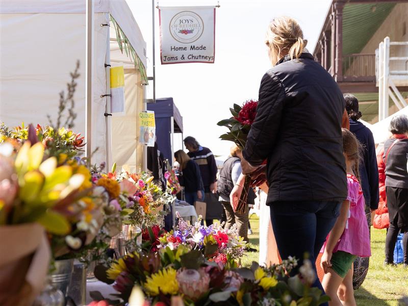 People shopping for flowers at the market.