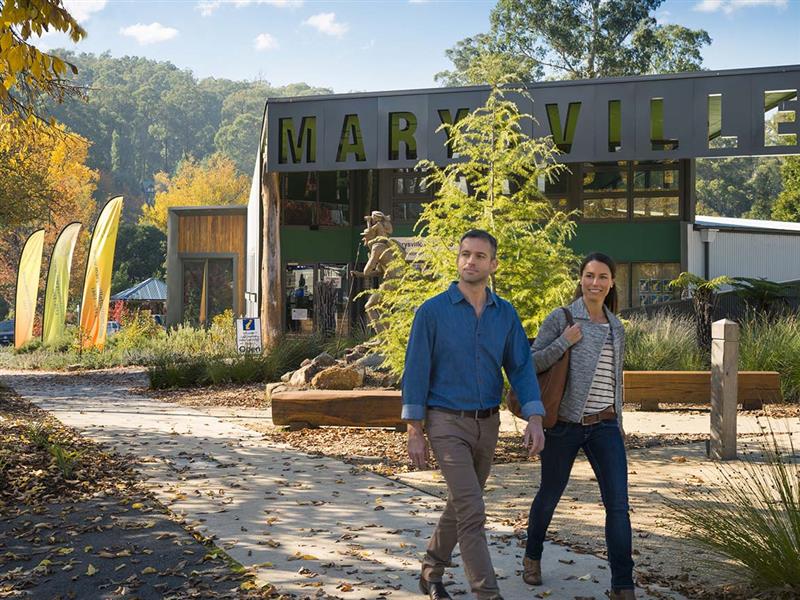 Couple outside Marysville Lake Mountain Visitor Information Centre, Marysville, Yarra Valley and the Dandenong Ranges, Victoria, Australia